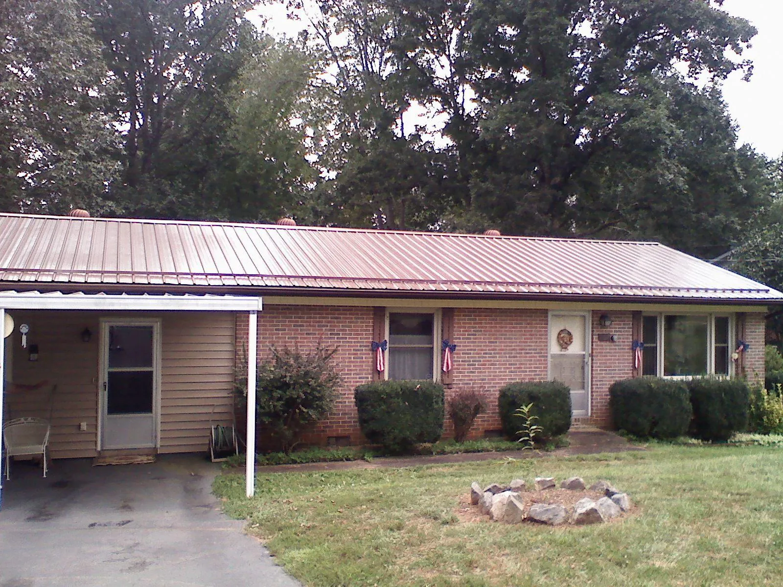 Bronze metal roof and carport on a brick ranch home — Roof Repair work by our crew in Chicago